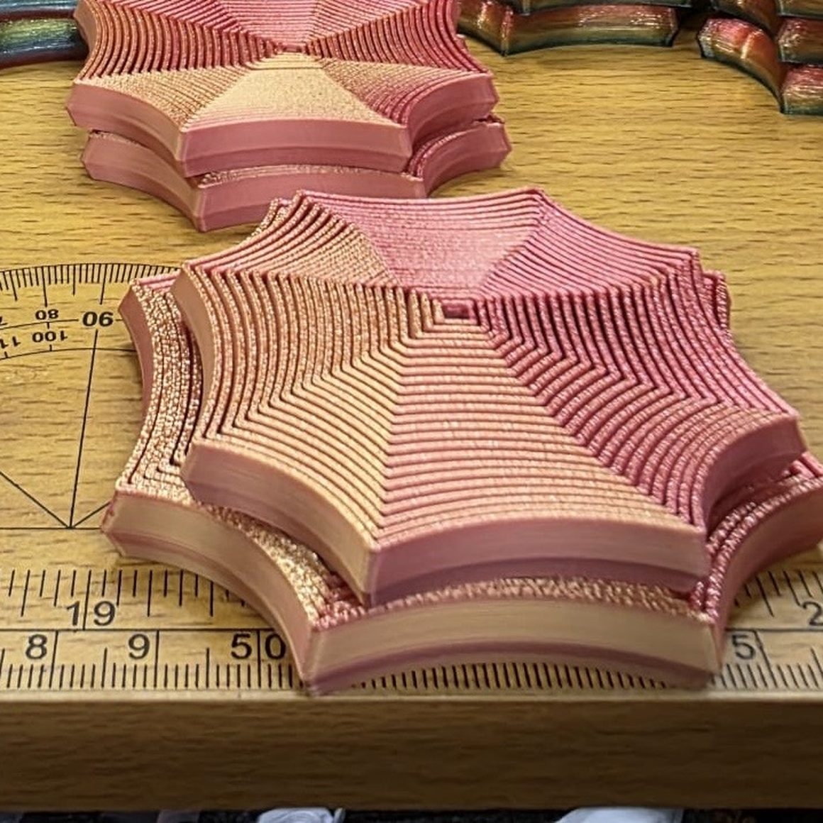 Finished Focus Spirals in several colourways on the studio bench, beside a rule