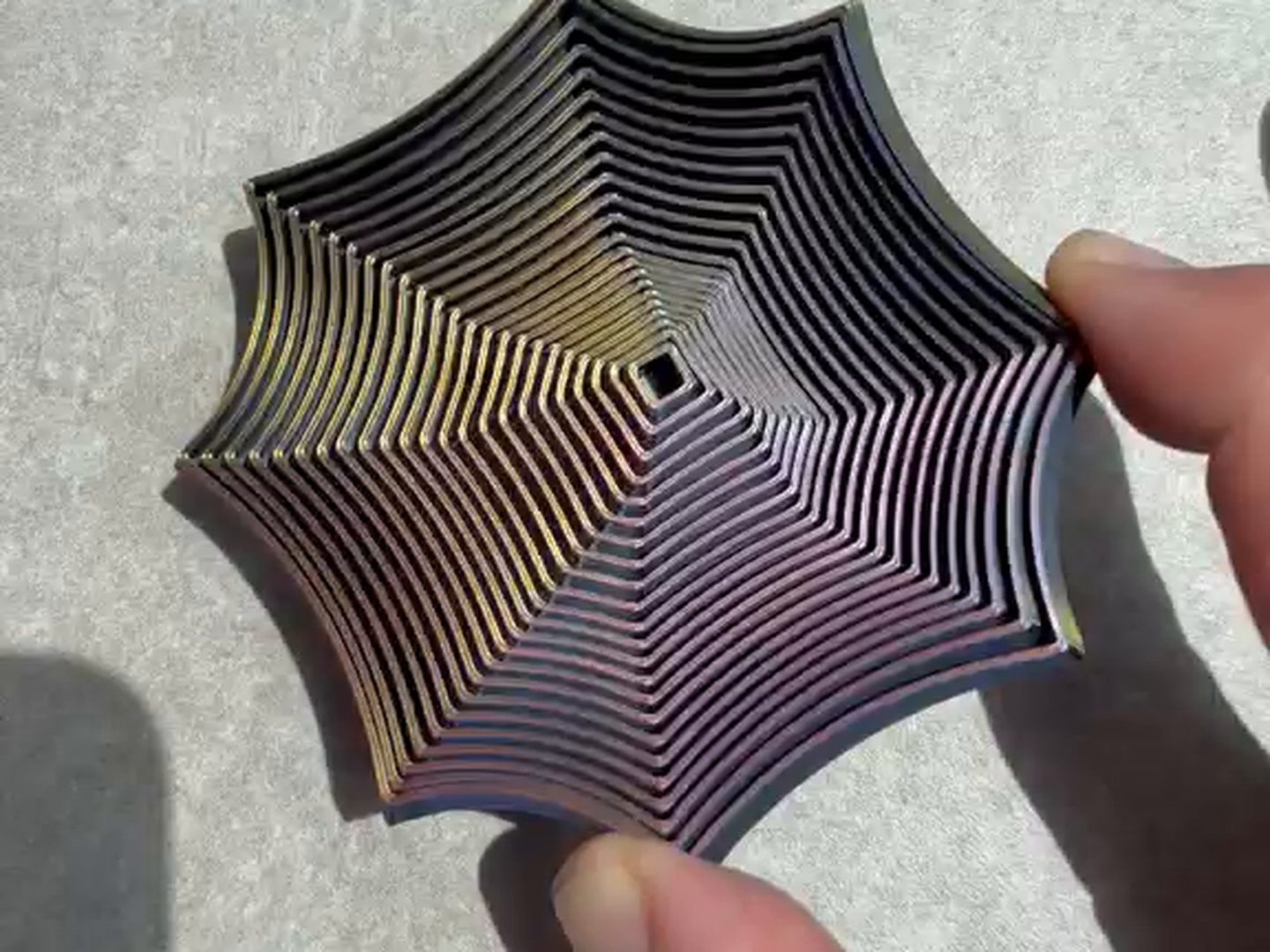 A Focus Spiral focus toy open flat in an adult hand